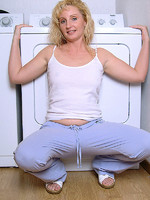 michelle spreads her long legs on top of the washing machine