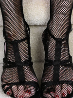 redheaded grandma in a fishnet body stocking plays with her feet